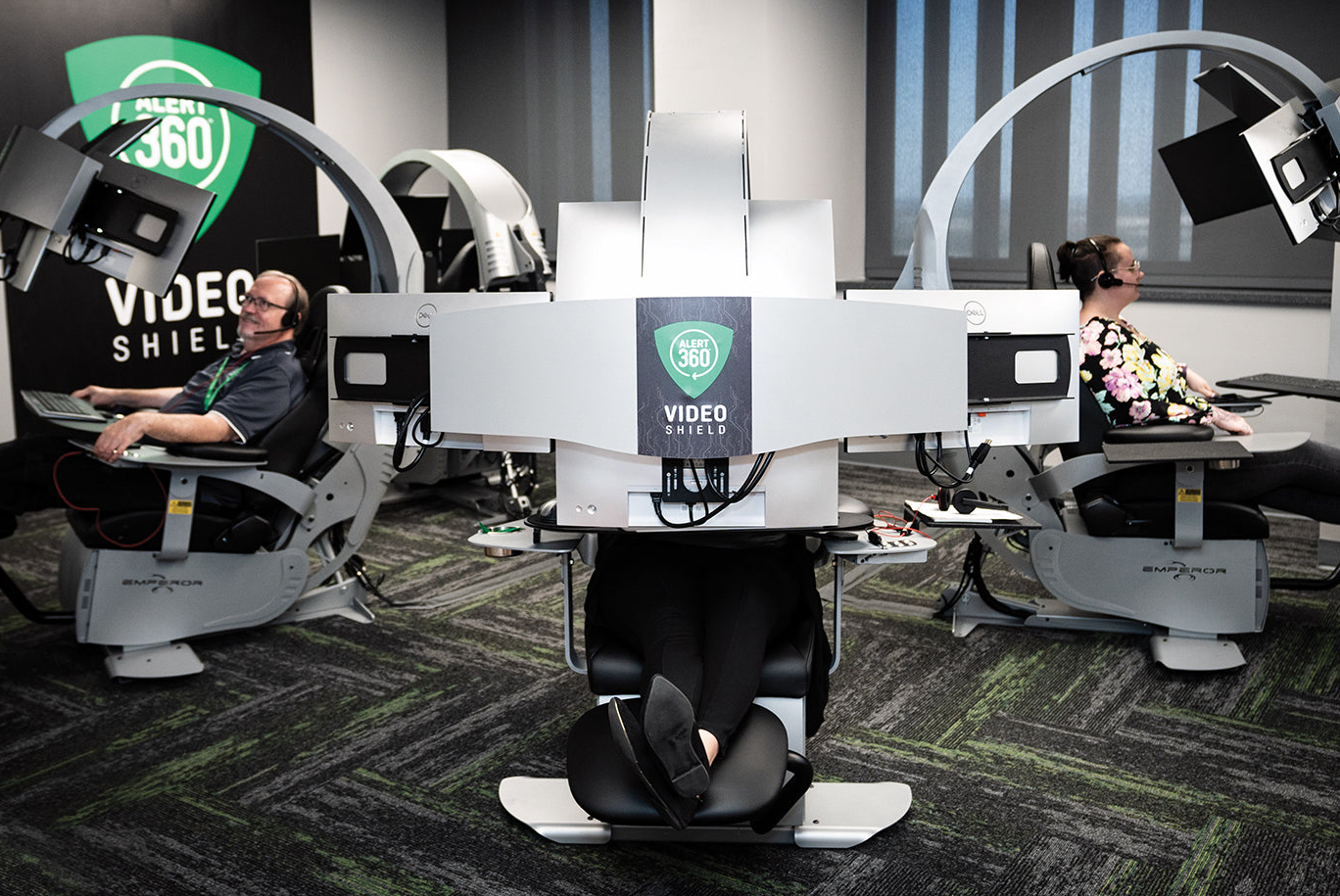 Simulator room with people using video simulation equipment, featuring the Video Shield brand.