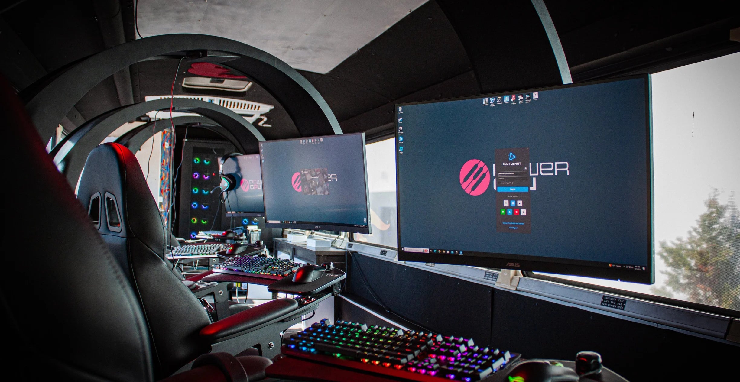 Gaming setup with the Emperor chair, multiple monitors and gaming equipment in a vehicle interior.